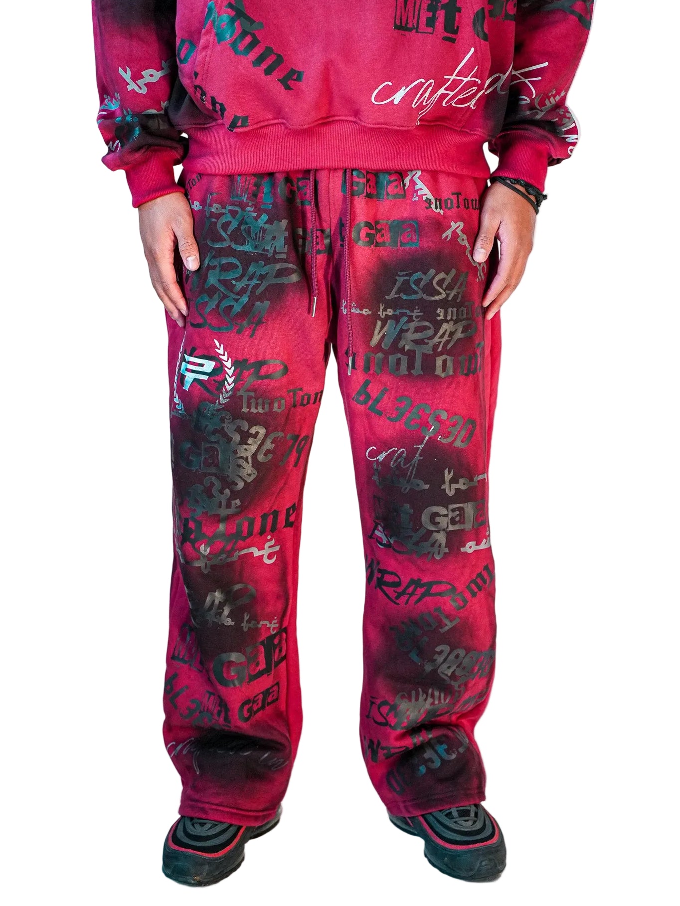 Person wearing a red hoodie and pants with text pattern on a white background