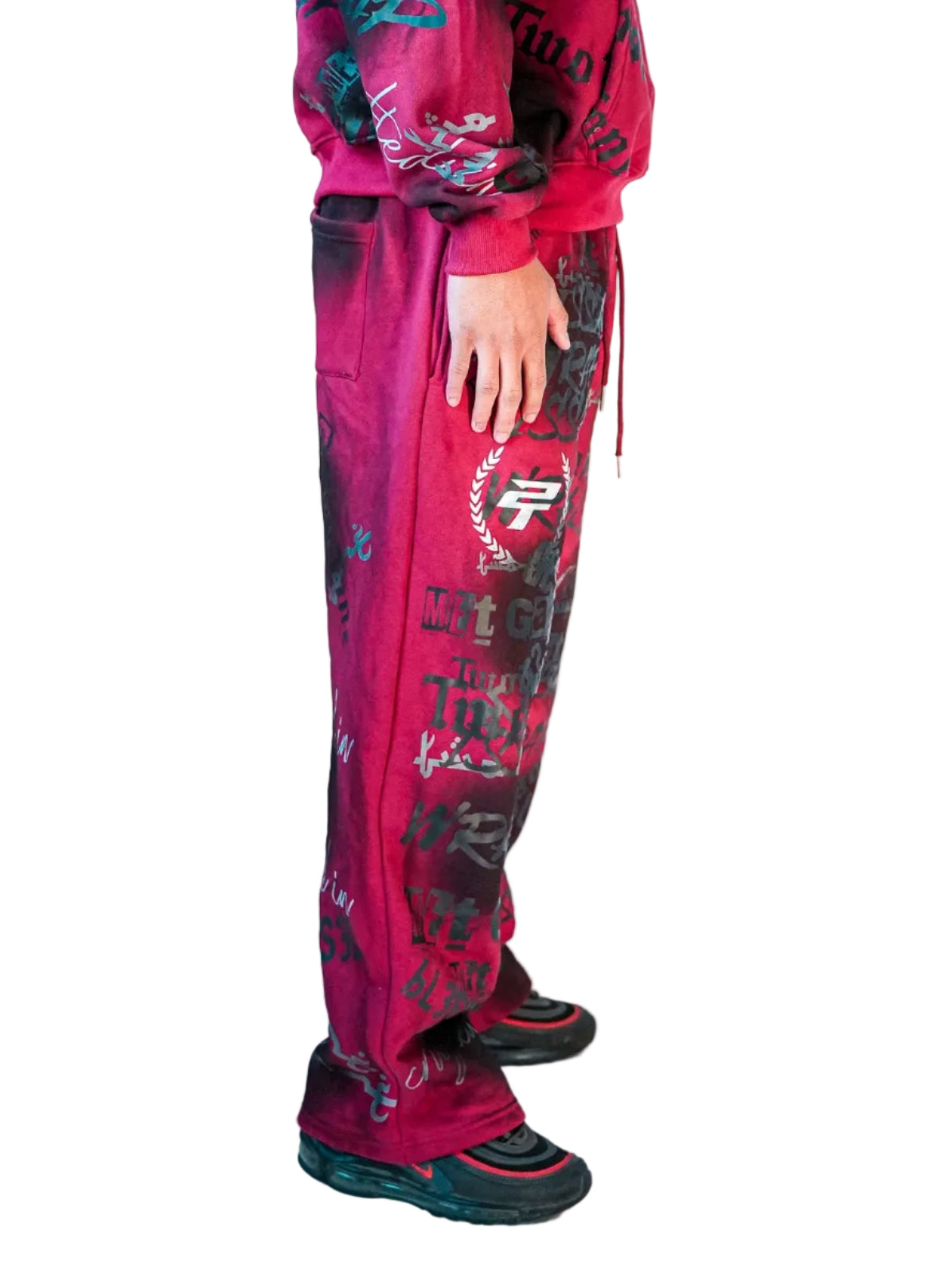 Person wearing a pink tracksuit with black and blue graphics on a white background